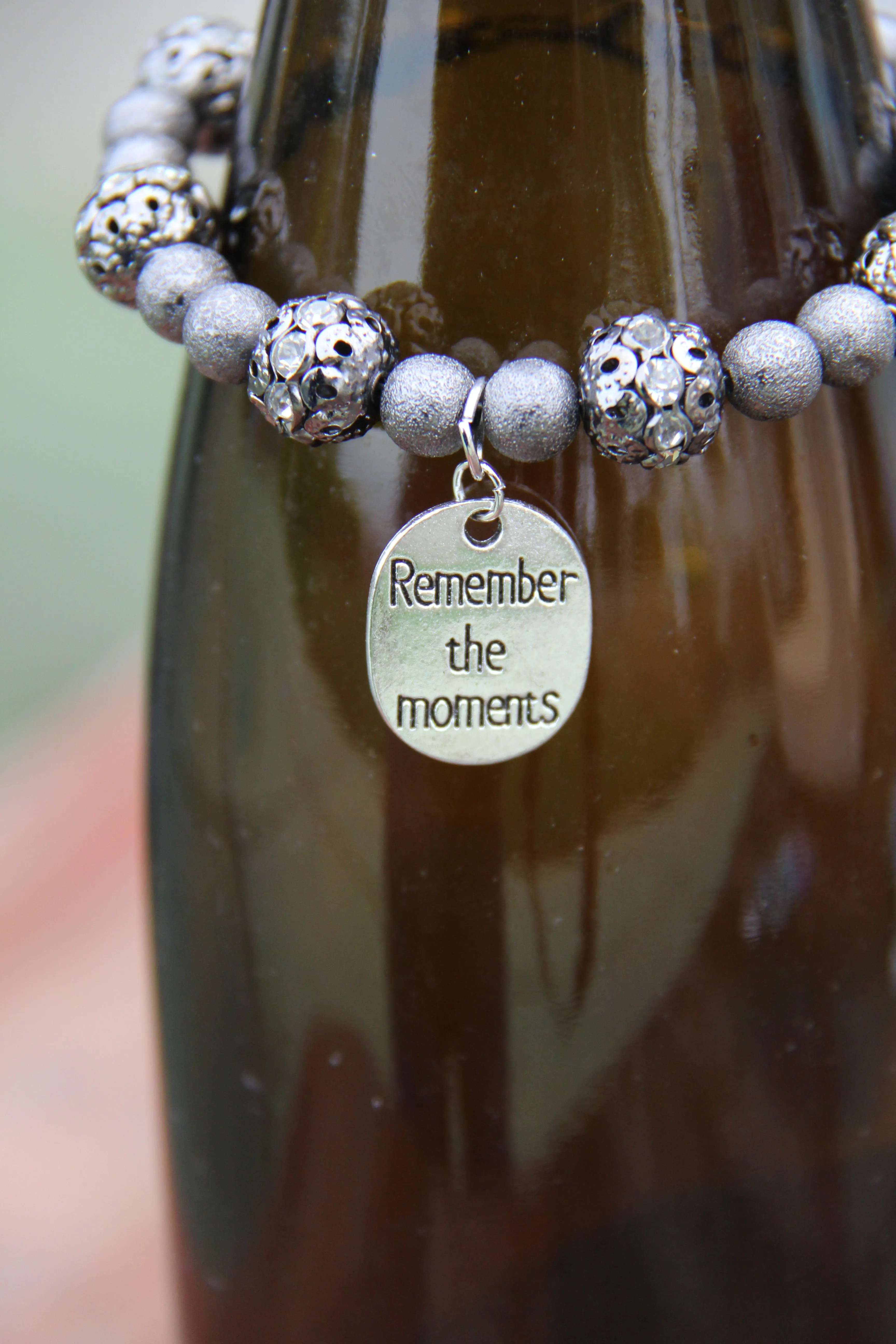 Grey colored lite weight beads with "Remember the moments" silver charm